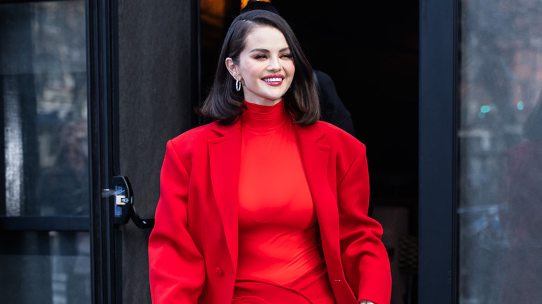 Selena Gomez walking in a red outfit