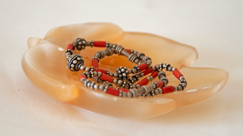 pink selenite bowl holding beads