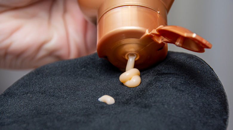 person pumping self-tanner