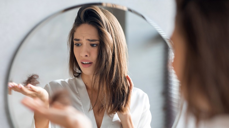 Woman losing strands of hair