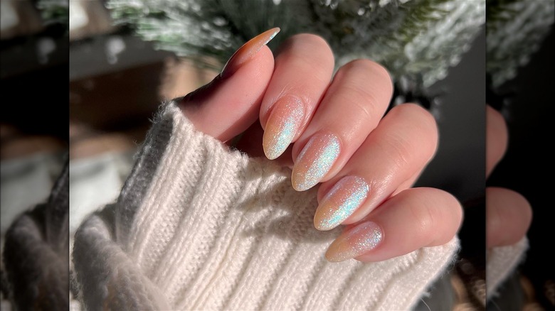 hand with holographic white shimmer nails