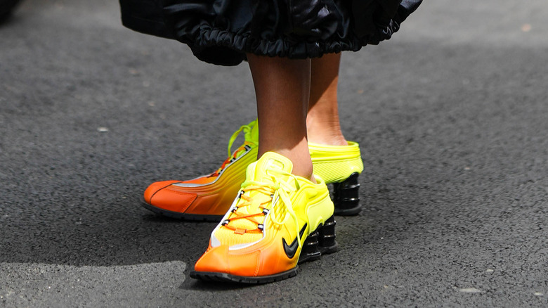 woman wearing chunky neon sneakers