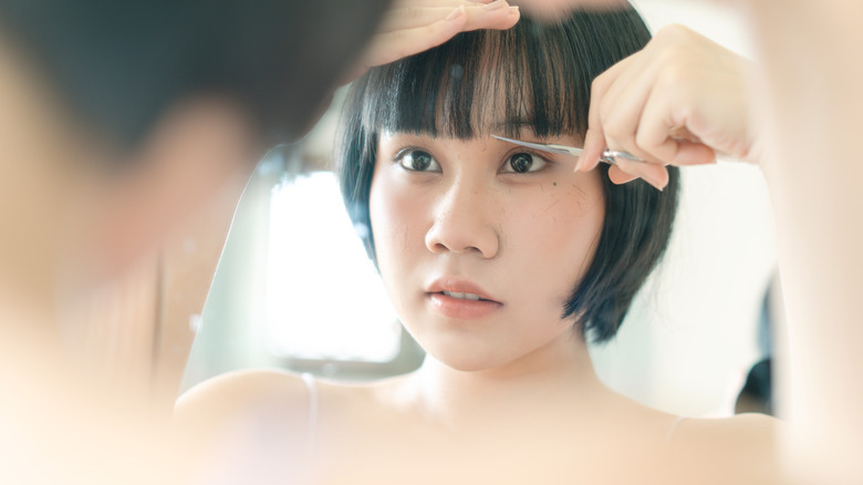 woman cutting bangs