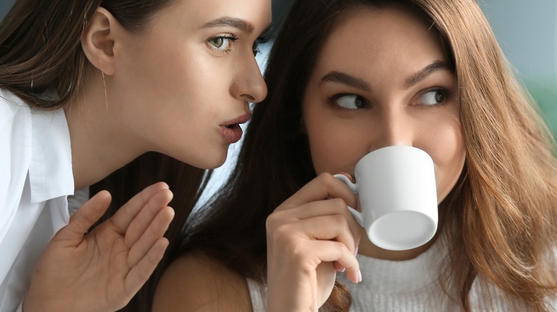 girls whispering and gossiping