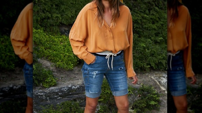 Woman models long blue jean shorts 