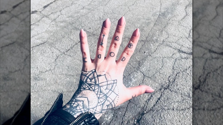 hand with neutral short stiletto nails