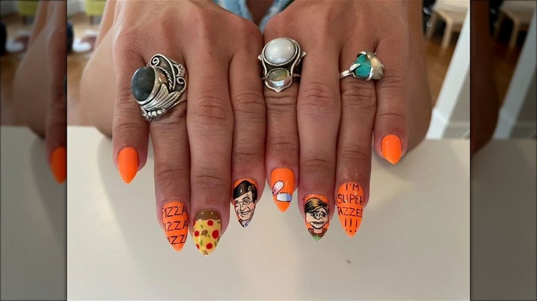 hand with short stiletto cartoon nails