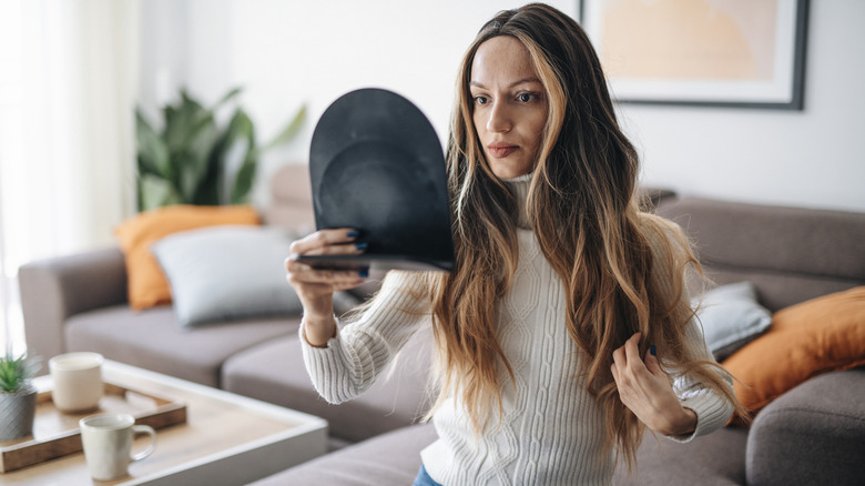 Woman assessing wig in mirror