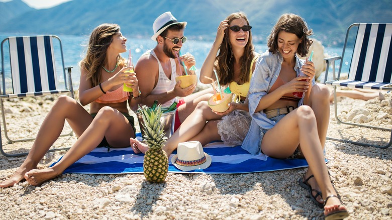 friends laughing on a beach