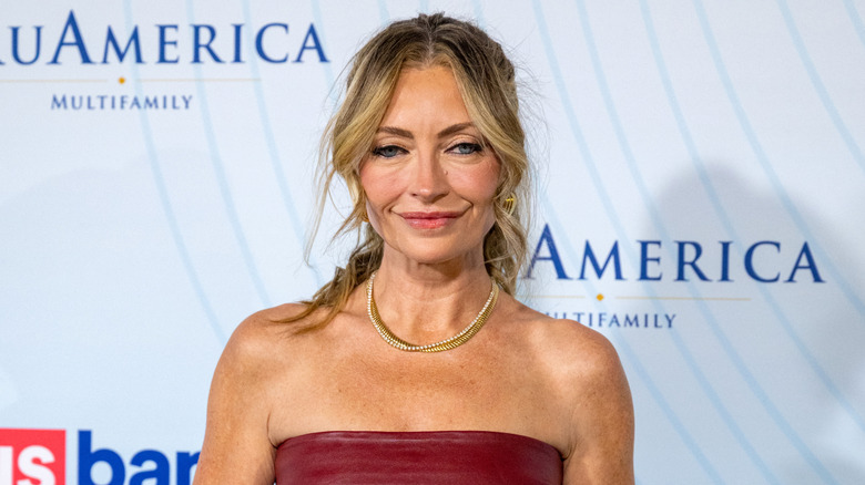 Rebecca Gayheart posing in a red dress