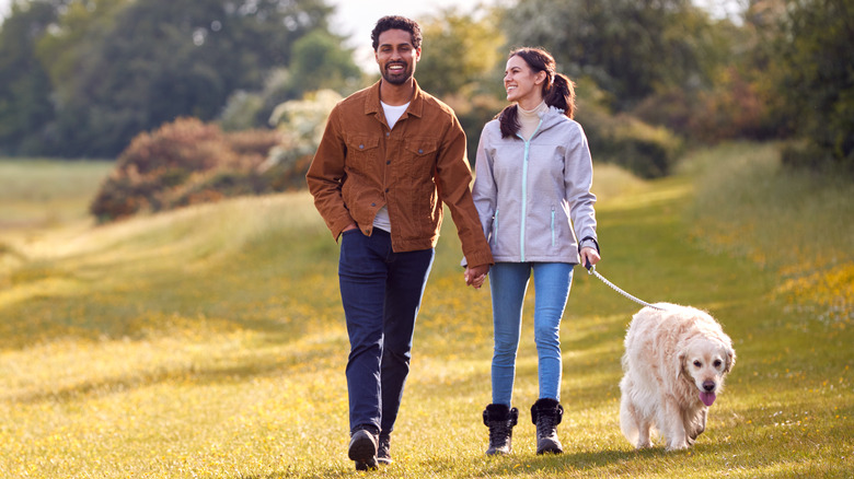 Couple walking their dog