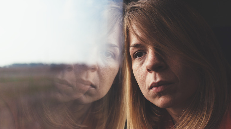 woman leaning against window