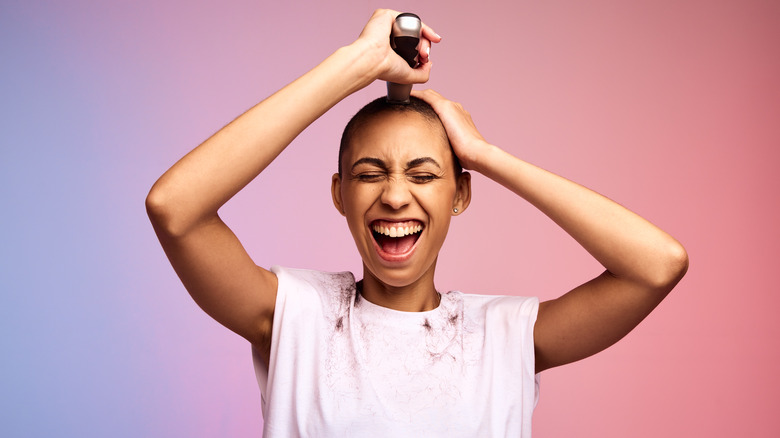 person shaving their head