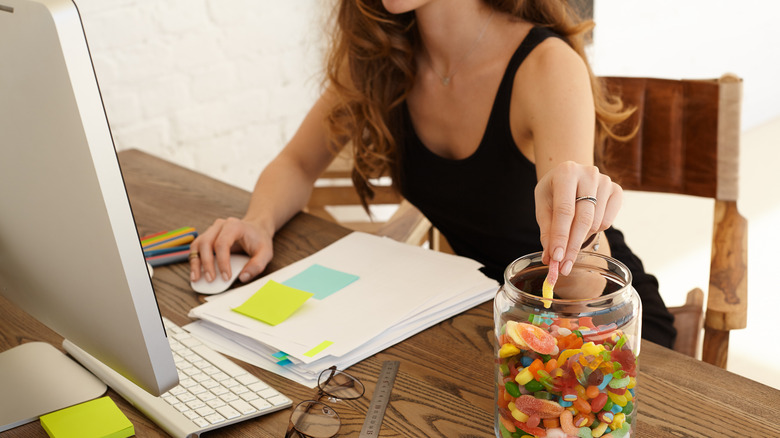 Woman stress eating gummy candy