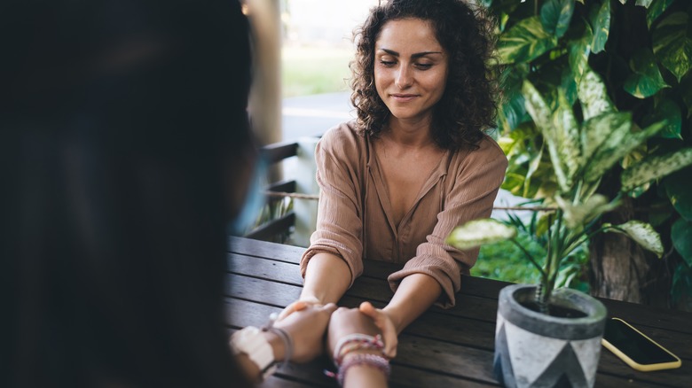 A couple holding hands at a table