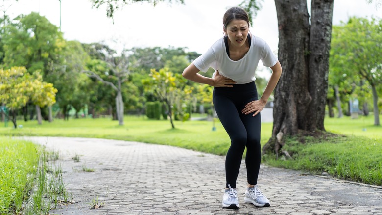 Woman in pain, touching hip area
