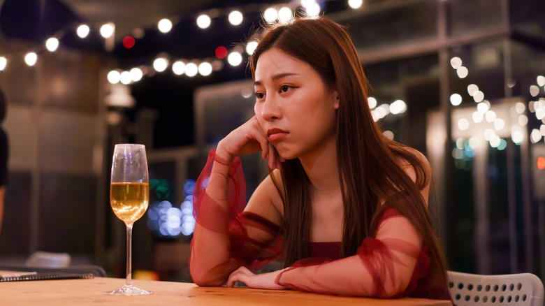 Sad woman alone at bar