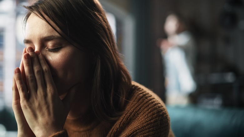 Crying woman with shouting partner