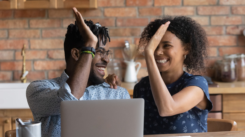 Partners high fiving 