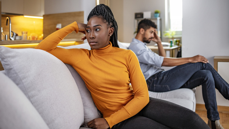 Couple breaking up on a couch 