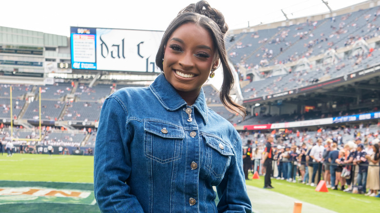 Simone Biles wearing a denim jacket to a Chicago Bears game