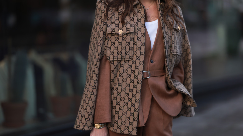 woman wearing brown outfit with gold watch