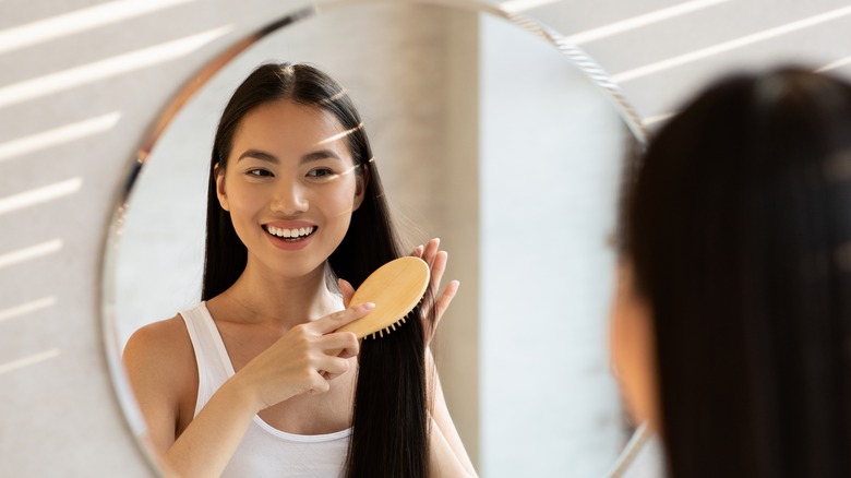 woman brushing long hair