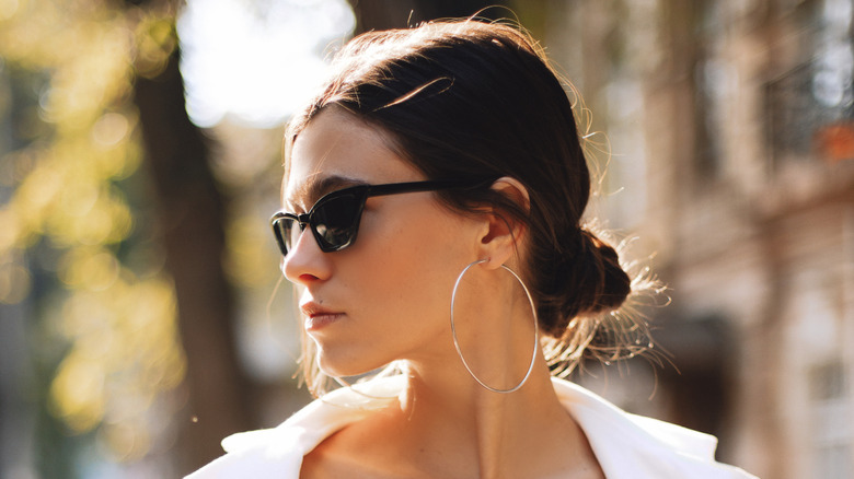 woman with sunglasses and low bun