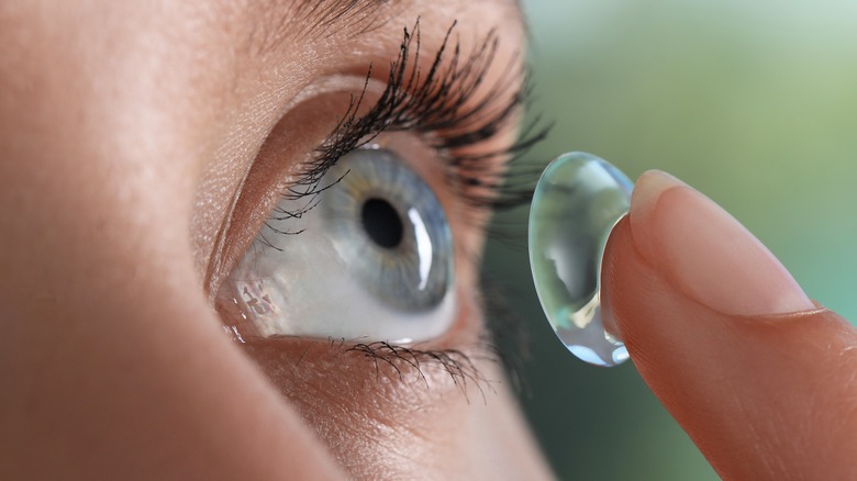 Person putting in contacts