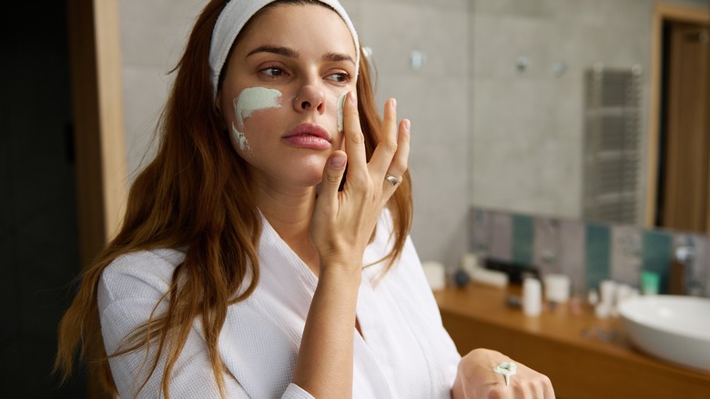 Woman applying a face mask