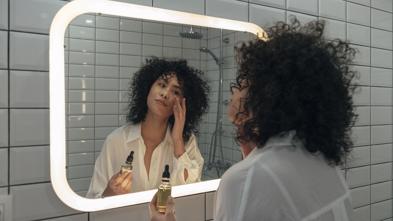 woman applying hydrating serum