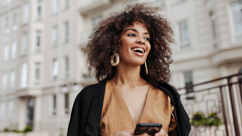 smiling woman walking in the city
