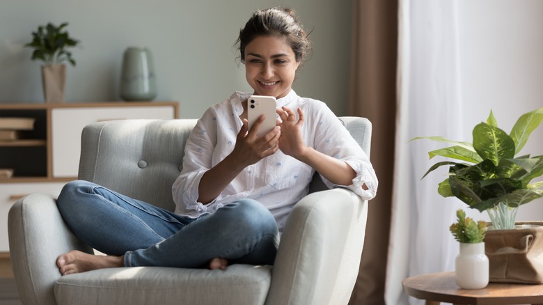 Woman watches videos on phone 