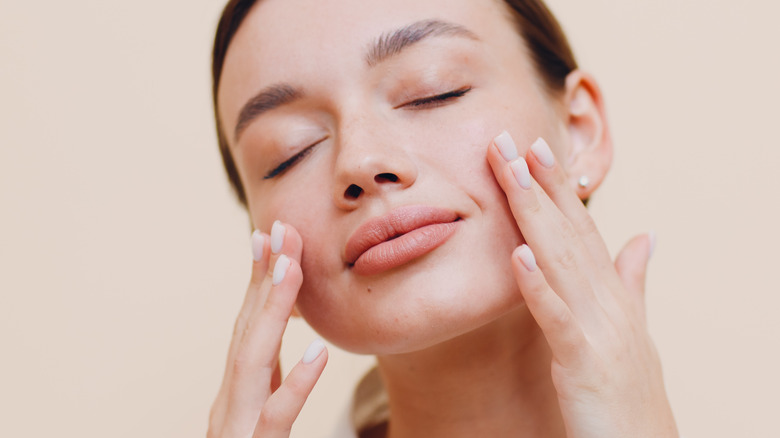 woman massaging skin