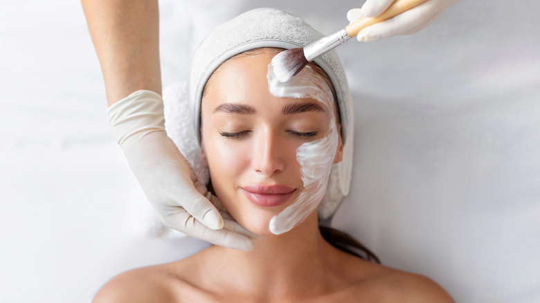 A woman getting a facial treatment.