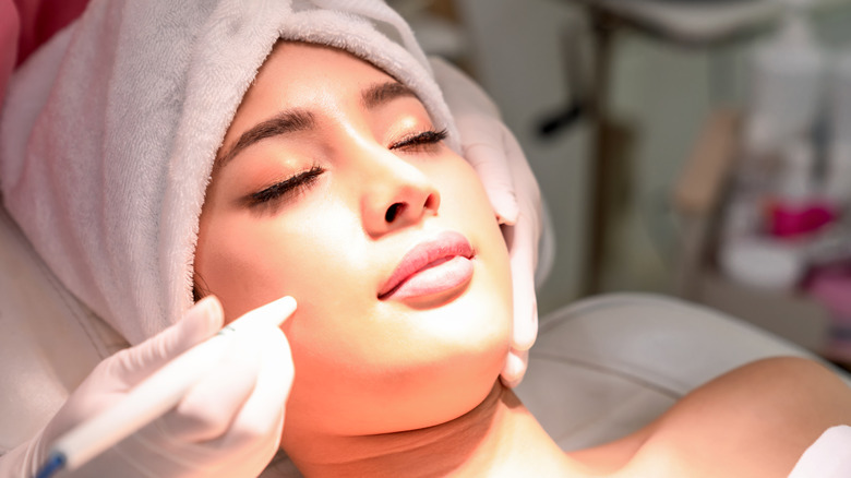 A woman getting a facial treatment.