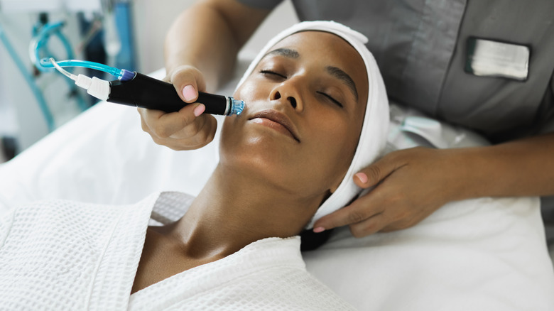 A woman getting a microneedling treatment.