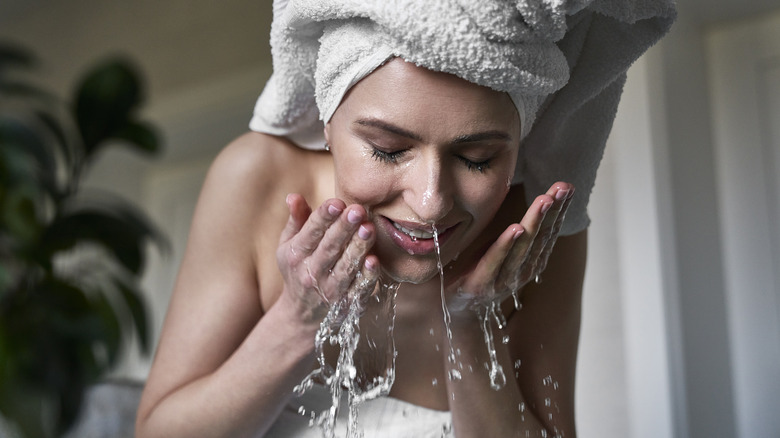 Woman washing her face