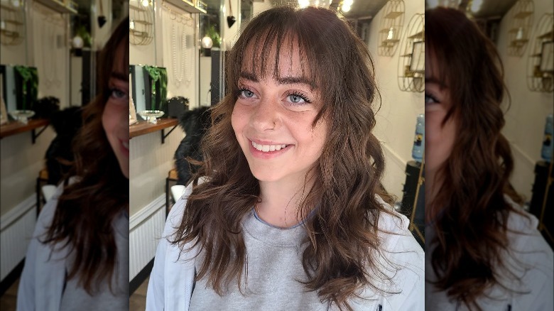 Woman with skinny fringe and barrel curls 