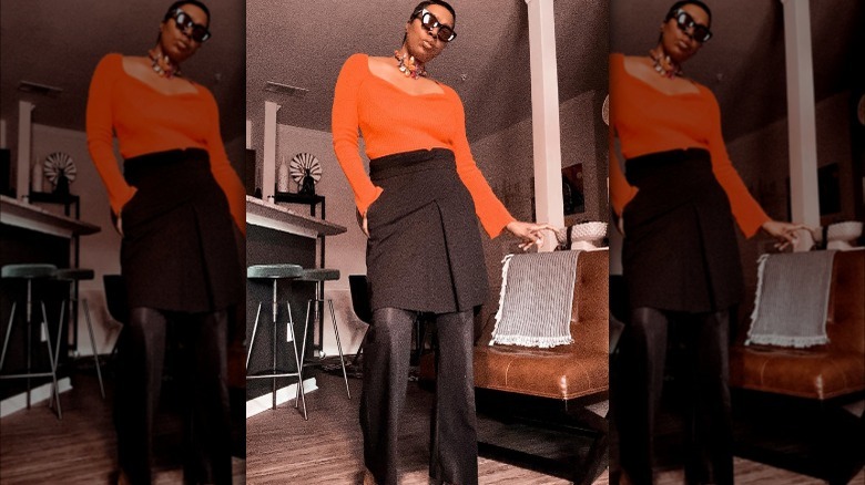 Black skirt over black pants orange shirt