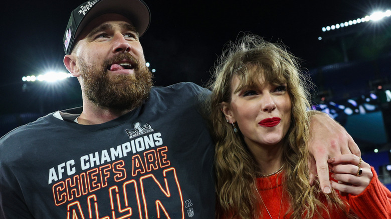 Taylor Swift and Travis Kelce celebrating on the football field