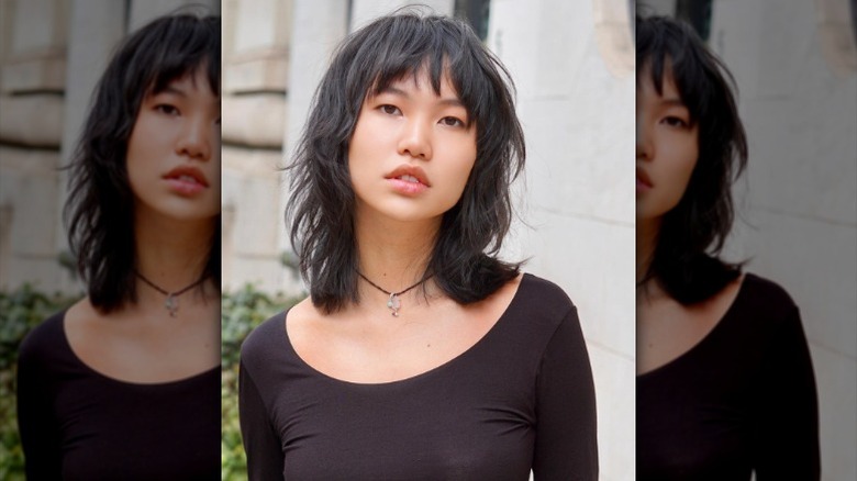 Woman with ashy brown wolf cut