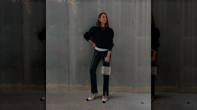 Woman carrying a snakeskin handbag