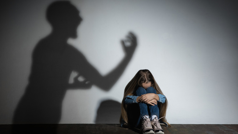 shadow of person yelling; child cowering