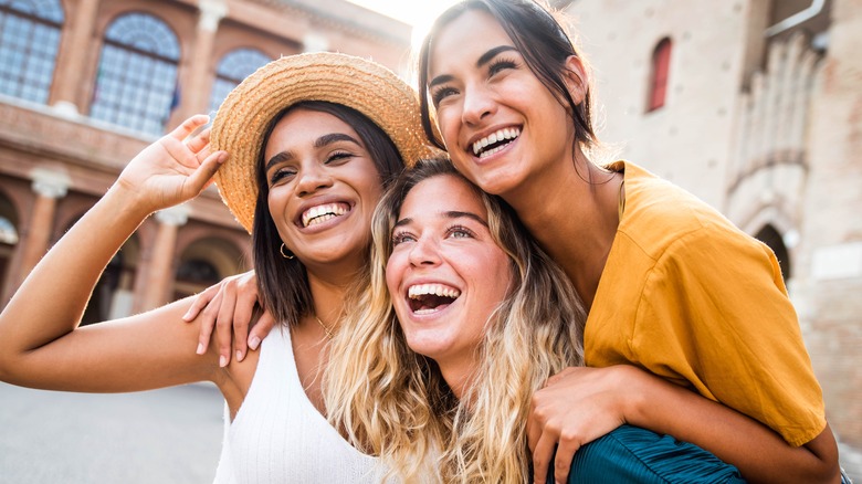 three people smiling