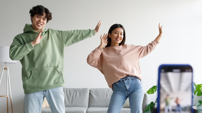 couple recording dancing on phone