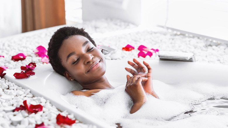 Woman relaxing in bubble bath