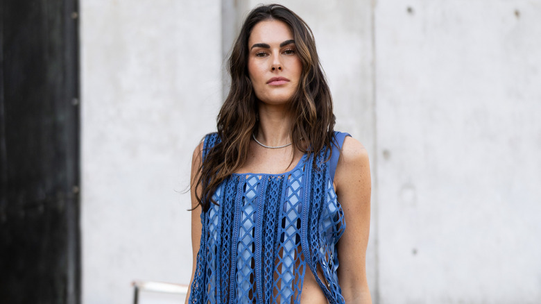 A woman wearing a blue fringe top