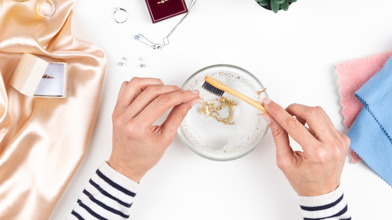 woman hand cleaning jewelry