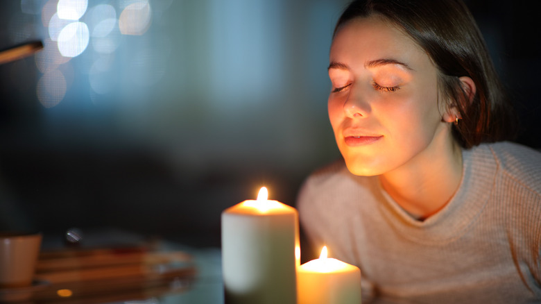Person smelling candle